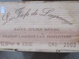 a box of wine sitting on top of a wooden table