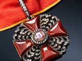 an image of a red ribbon with a gold cross on it