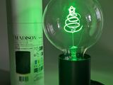 a green light bulb sitting next to a bottle of deodorant