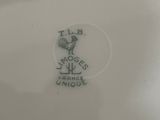 a white plate with a black rooster on it