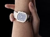 a woman that is holding onto a wrist with a watch on it