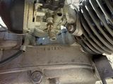 a close up of a motorcycle engine on a brick floor