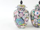 two vases with flowers painted on them on a white background