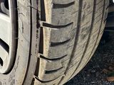 a close up of a car tire on a gravel road