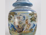 a blue and white vase with a painting on it
