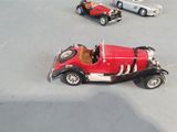 three toy cars that are sitting on a table