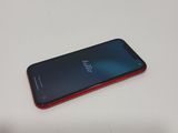 a close up of a red and black phone on a table
