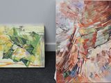 two paintings of different colors and shapes are on the floor