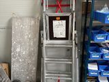 a ladder that is sitting next to a pile of boxes