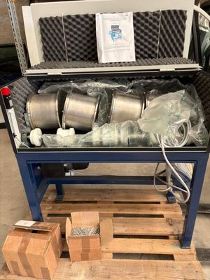 a large metal container with a bunch of items inside of it