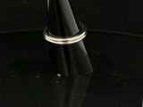 a close up of a silver ring on a black surface
