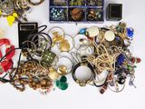 a lot of jewelry sitting on a table together