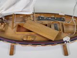 a model of a boat with a sail on a stand