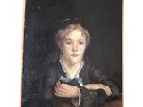 portrait of a young woman with a blue bow tie by a table