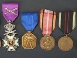 several medals are arranged in a row on a black surface