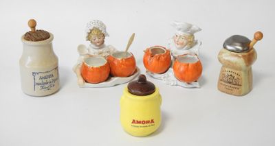 several figurines of children and a jar of milk on a white surface