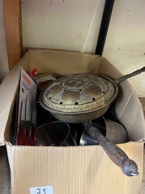 a cardboard box with a bunch of kitchen utensils in it