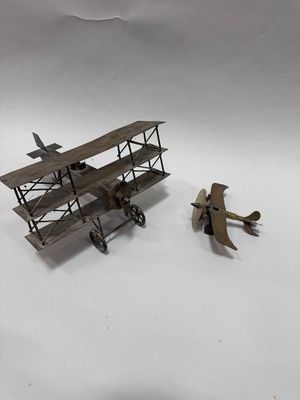 a small model of a plane and a small model of a plane on a white surface