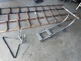 a picture of a metal bed frame and some tools on the floor