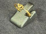 a lighter that is on the ground with a ring on top of it