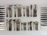 a lot of different types of silverware on the table
