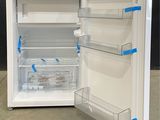 an open refrigerator that is sitting on the floor