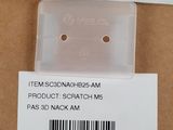 the back of a box with a pair of earrings in it