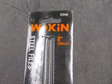 pair of black and orange scissors sitting on top of a gray surface
