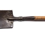 a close up of a metal shovel with a wooden handle on a white surface