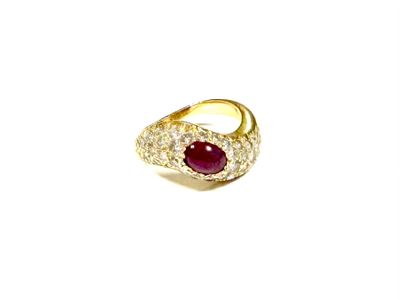 an image of a gold ring with a ruby stone in the center