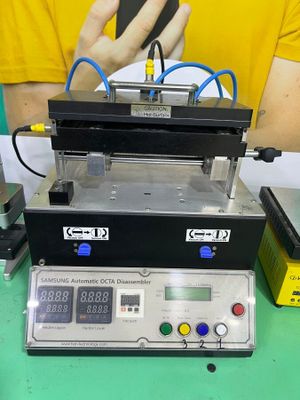 a machine that is sitting on a table with a cell phone in front of it