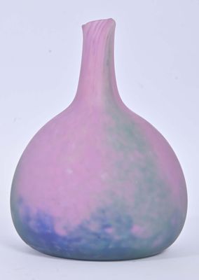 a purple and blue vase sitting on a white surface