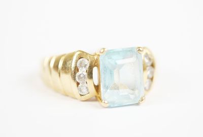 an image of an aquamarinee and diamond ring on a white background