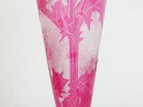a glass vase with a pink design on it