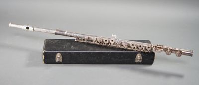 a flute sitting on top of a book on a table