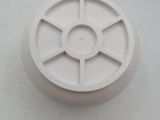 a white plastic object on a white surface