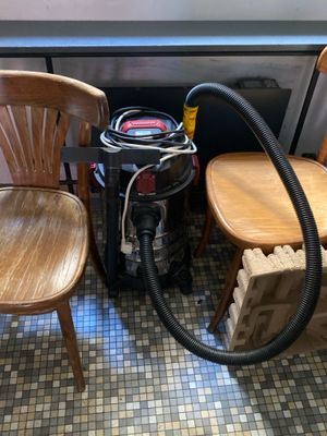 two chairs and a vacuum in a room