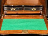 a wooden desk with a green mat on top of it