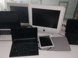 three laptops and a cell phone sitting on a desk