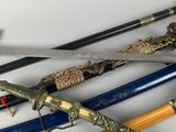 many different types of swords on a white surface