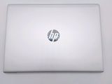 hp laptop computer sitting on a white surface with the lid open