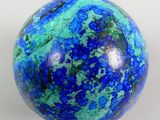 an image of a blue and green marble ball on a white surface