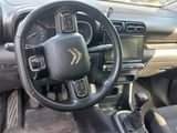 the interior of a car with a steering wheel and dashboard controls