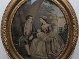 une vieille photo représentant une femme et un enfant, dans un cadre doré