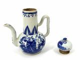 a small blue and white tea pot and a small cup
