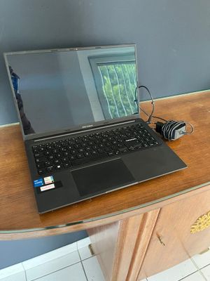 a laptop computer sitting on top of a wooden desk