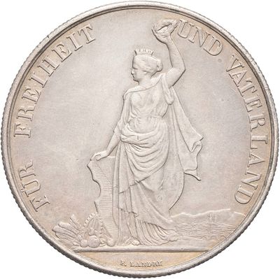 a close up of a silver coin with a woman holding an umbrella
