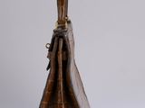 the brown crocodile skin purse is open and ready to be used