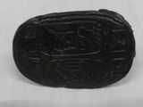 a close up of a small black object on a white surface