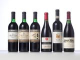 six bottles of wine lined up in a row on a table
